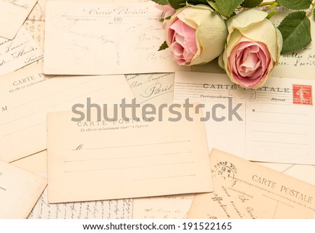 vintage postcards and soft rose flowers. old love letters. romantic still life