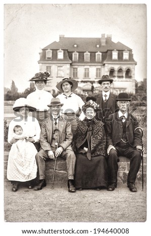 BERLIN, GERMANY - CIRCA 1900: old photography of a wealthy family with his house on background. antique picture with original film grain