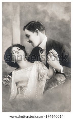 PARIS, FRANCE - CIRCA 1908: young romantic couple in love. rare antique sepia picture with original film grain