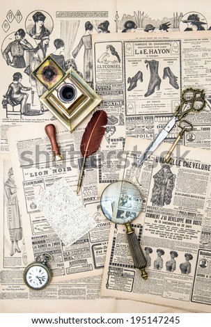 antique accessories, sewing and writing tools, vintage fashion magazine for the woman. aged paper background