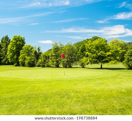 Green field and beautiful blue sky. Golf course landscape