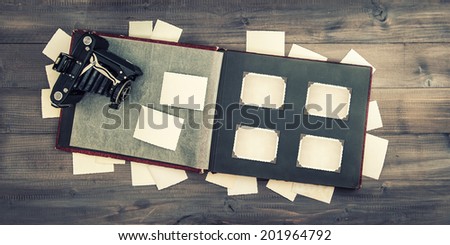 vintage camera and photo album with corners and frames. retro style toned picture