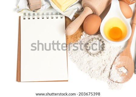 recipe book and baking ingredients eggs, flour, sugar, butter, yeast. food background