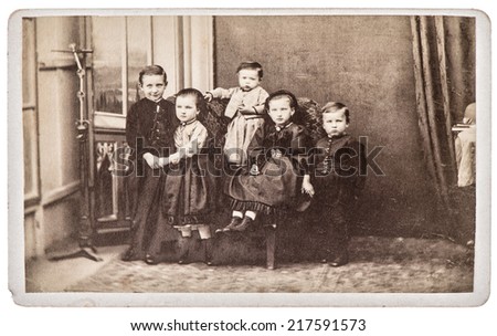 old family photo with five children. brothers and sisters. nostalgic vintage picture from ca. 1880 with original film grain, blur and scratches