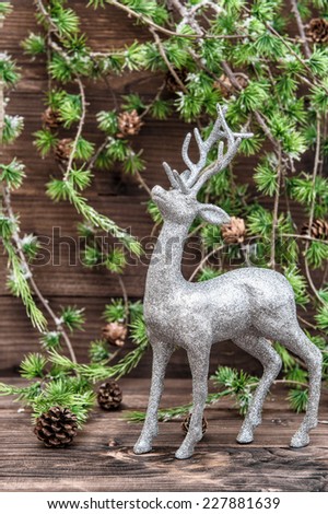 Christmas deer. Vintage style decoration with christmas tree bunch on wooden background