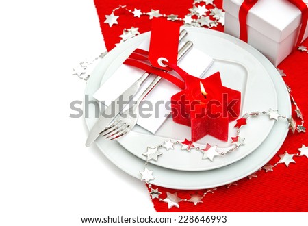 christmas table place setting decoration in red and silver. candle light dinner. holidays background