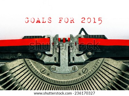 Old typewriter with sample text GOALS FOR 2015. Red words on white paper