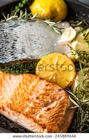 Grilled salmon fish with fresh herbs, garlic and lemon. Healthy seafood