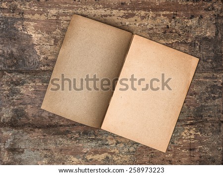 Antique empty journal on grungy wooden background. Paper texture. Vintage style toned photo