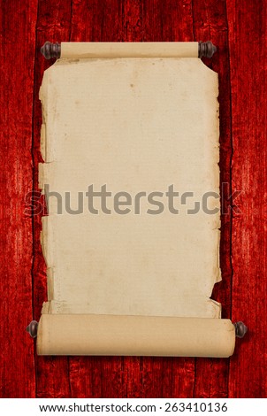 Vintage blank aged paper scroll on red wooden background with copy space. Antique style parchment manuscript