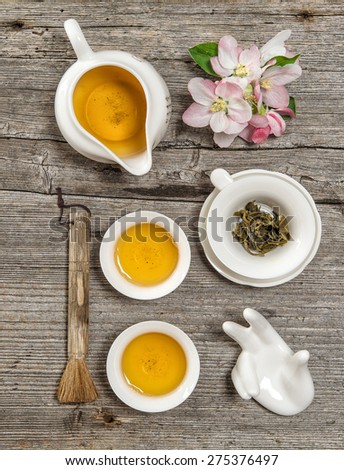 Teapot and cups on rustic wooden table. Utensils for traditional chinese tea ceremony