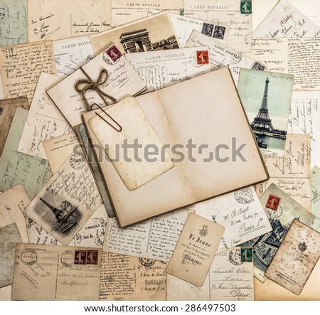 Open book, old letters and postcards. Vintage style paper background. Travel scrapbook for France and Paris