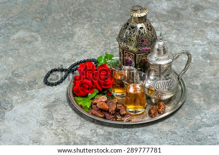 Tea and red rose flower, arabian lantern and rosary. Islamic holidays decoration. Ramadan kareem. Oriental hospitality concept