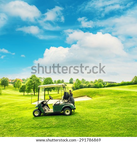 Golf course landscape with a cart over blue sky background Retro style toned picture