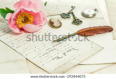 Old letters, pink rose peony flower and antique feather pen. Romantic vintage background