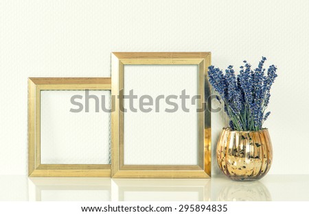 Golden picture frame and lavender flowers. Vintage style mockup for your photos and arts. Retro toned