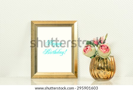 Picture mock up with golden frame and flowers. Vintage style interior. Sample text Happy Birthday! Retro toned photo