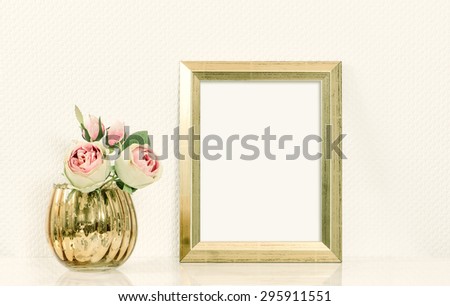 Picture mockup with golden frame and pink rose flowers. Vintage style toned picture