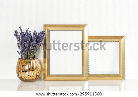 Golden picture frame and lavender flowers. Vintage style mock up for your photos and arts