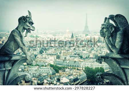 Stone demons gargoyle and chimera with Paris city on background. View from Notre Dame de Paris. Vintage style toned picture