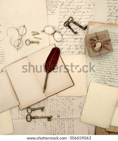 Vintage accessories, open book, old letters and documents. Sentimental nostalgic background. Retro style toned picture