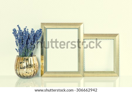 Golden picture frame and lavender flowers. Vintage style mock up for your photos and arts. Retro toned image