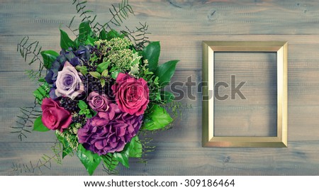 Golden picture frame and rose flowers bouquet. Vintage style mock up with space for your picture or text. Retro toned picture
