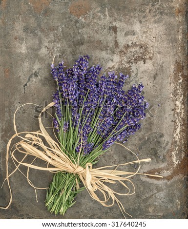 Lavender flowers with shabby chic style decorations. Fresh blossoms over rustic metal background