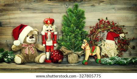 Christmas decoration. Vintage toys Teddy Bear, rocking horse and Nutcracker. No name mass production ware. Retro style toned photo with vignette
