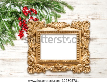 Christmas decoration with golden picture frame on wooden background. Winter holidays
