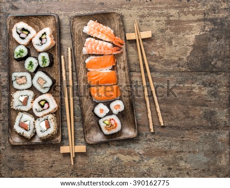Traditional japanese food. Sushi rolls, maki, nigiri on rustic wooden background. Seafood