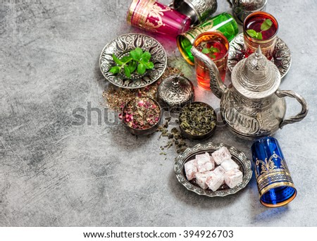Tea with mint leaves and rose flower petals. Oriental hospitality concept. Holidays table setting. Ramadan kareem