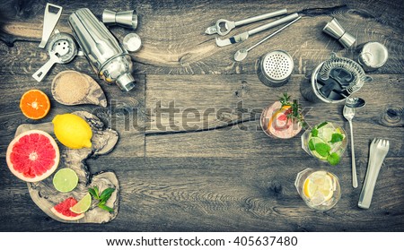 Fruit drinks with ice. Cocktail making bar tools, shaker, glasses. Flat lay. Vintage style toned picture