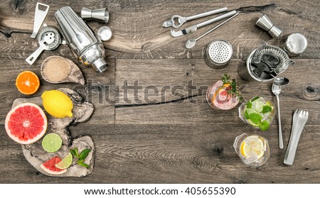 Fruit drinks with ice. Cocktail making bar tools, shaker, glasses. Flat lay.
