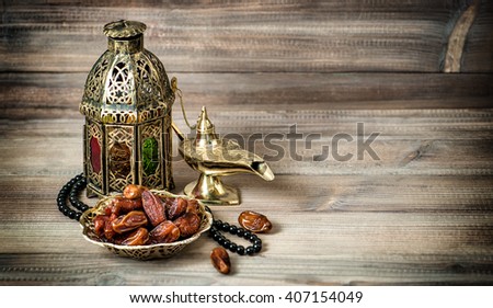 Arabian lantern, golden lamp and fruits. Islamic holidays decoration. Vintage style toned photo