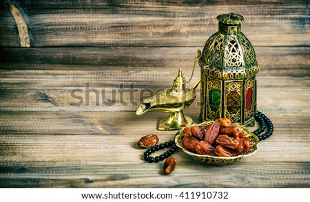 Arabian lantern, dates and rosary. Islamic holidays concept. Vintage style toned picture. Vibrant colors