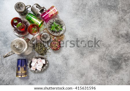 Festive arabic tea table setting. Oriental hospitality. Ramadan kareem. Muslim holidays. Islamic holidays. Tea drink. Herbal tea. Tea glasses. Tea pot. Tea cups