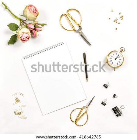 Artistic workplace flat lay. Paper, sketchbook, flowers, office tools and accessories. Flat lay, top view