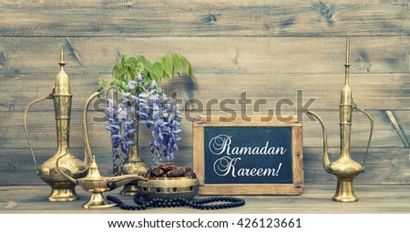 Ramadan kareem. Golden oriental decorations and islamic rosary beads.  Vintage style toned picture