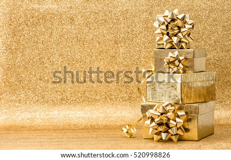 Gifts with ribbon bow on golden background. Holidays decoration. Christmas Birthday Valentines Day