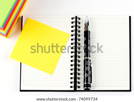 pencil on open note book. Colorful paper notes
