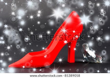 woman\' dreams and fantasies. Red women shoe with shiny crystal on black background