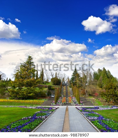 spring landscape with flowers and beautiful blue sky. public flower garden Mainau Island in Germany