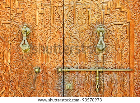 An antique ornate Mosque door with bronze door handles