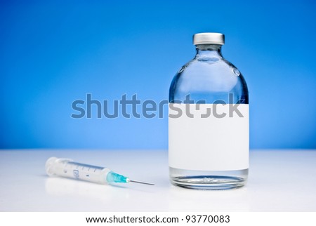 Medical still-life with a syringe and a drug vial with blank space