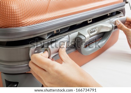 open suitcase with clothes on bed