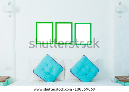 double colorful pillow in the bedroom with photo frame