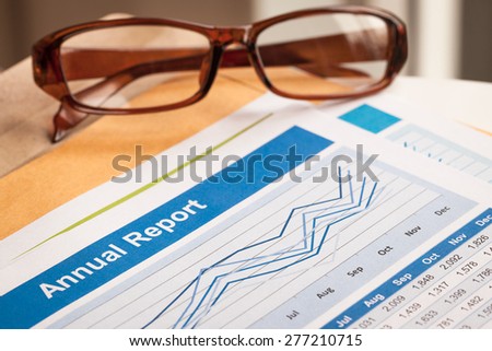 Annual Report letter document and eyeglass