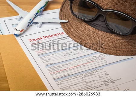 Travel Insurance Claim application form and hat with eyeglass on brown envelope, business insurance and risk concept; document and plane is mock-up