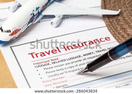 Travel Insurance Claim application form and hat with eyeglass and pen on brown envelope, business insurance and risk concept; document and plane is mock-up